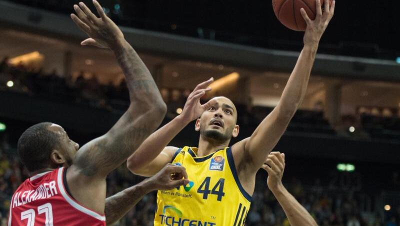 Albas Stefan Peno spielt den Ball zum Korb gegen Bambergs Cliff Alexander (l) und Bambergs Augustine Rubit (r). Foto: Annegret Hilse Albas Stefan Peno spielt den Ball zum Korb gegen Bambergs Cliff Alexander (l) und Bambergs Augustine Rubit (r). Foto: Annegret Hilse