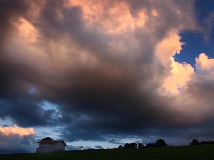Wolken leuchten im Abendlicht. Foto: Karl-Josef Hildenbrand/dpa